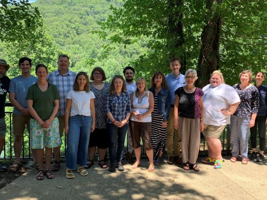Outside members of the community university team assemble for a research and planning retreat.